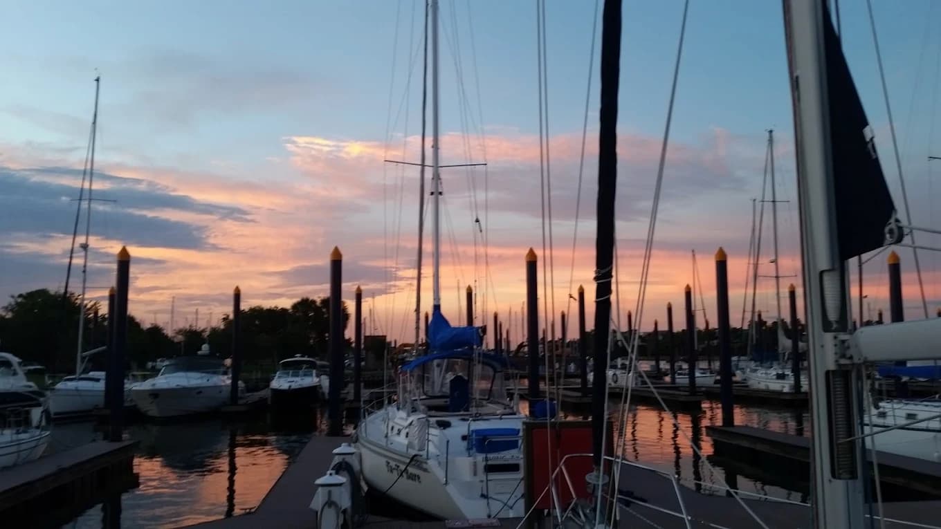 Sailboats docked at the Watergate marina at sunset