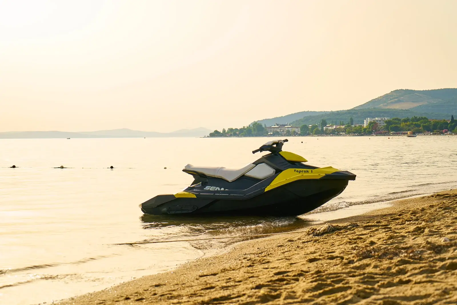 Sea-Doo jet ski on a calm beach shoreline at golden hour