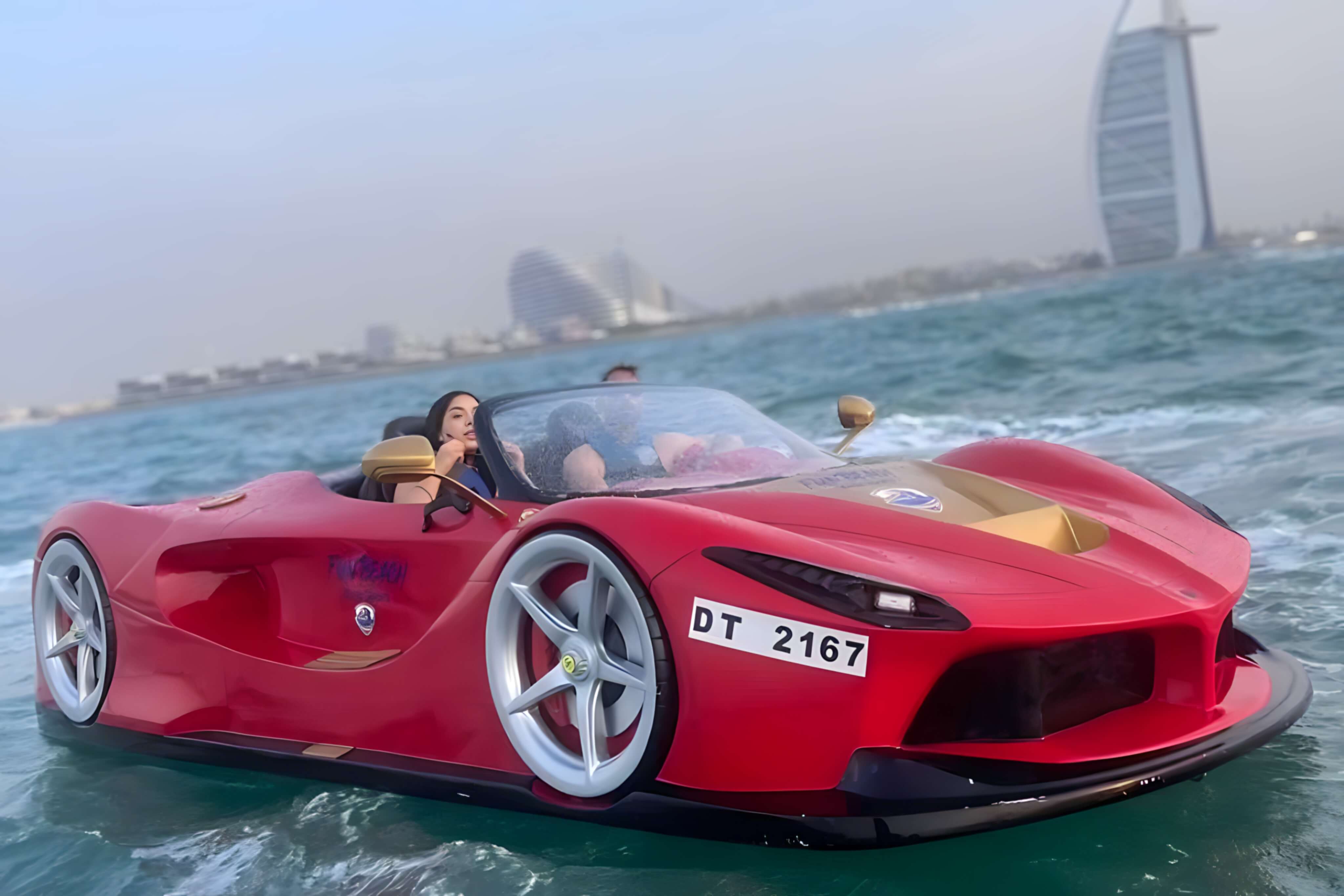 Red luxury jet car on the water in front of the Dubai skyline