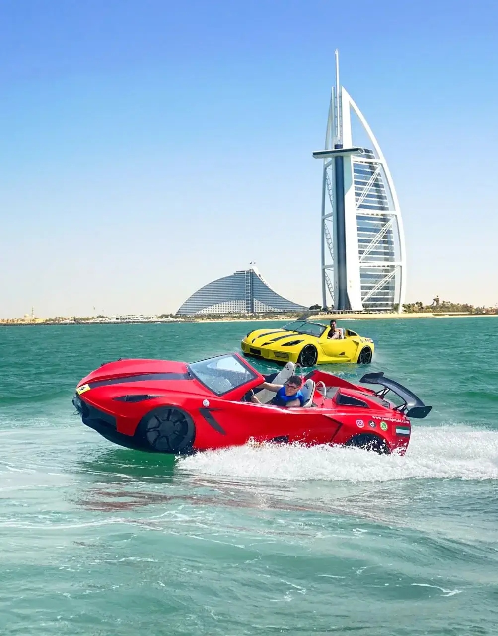 Red and yellow jet cars racing near the Burj Al Arab in Jumeirah, Dubai