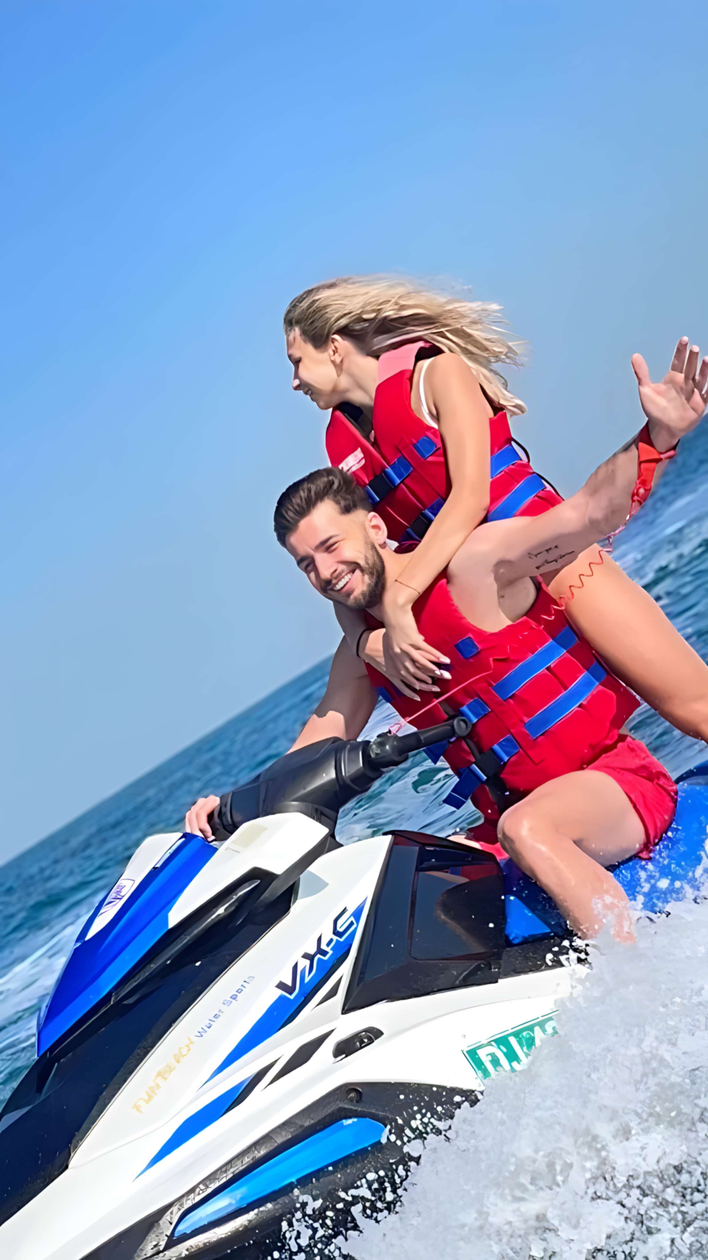 Friends riding jet skis together on the water in Dubai
