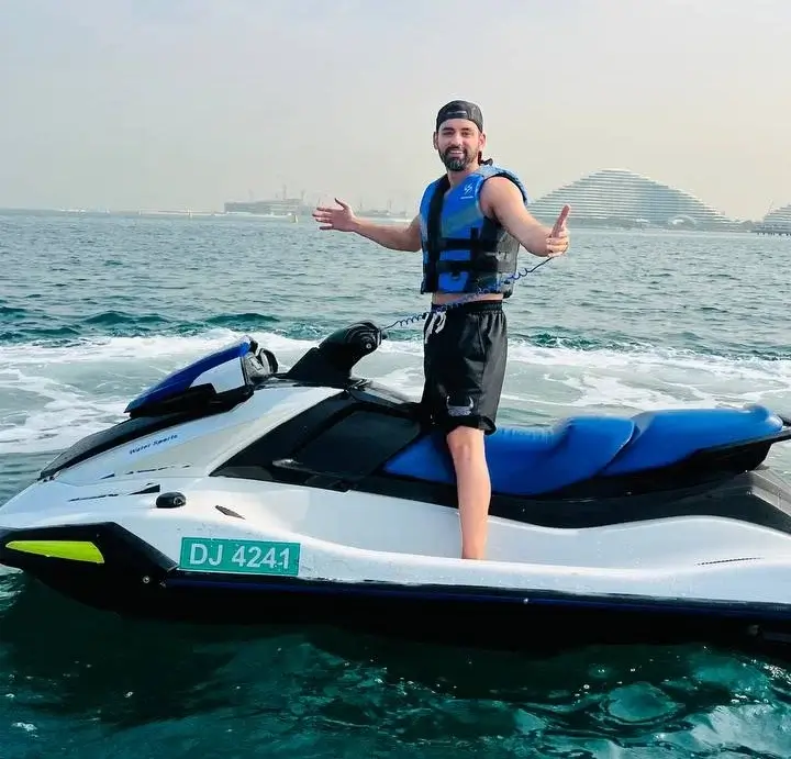 Rider standing on a jet ski wearing a life jacket in Dubai