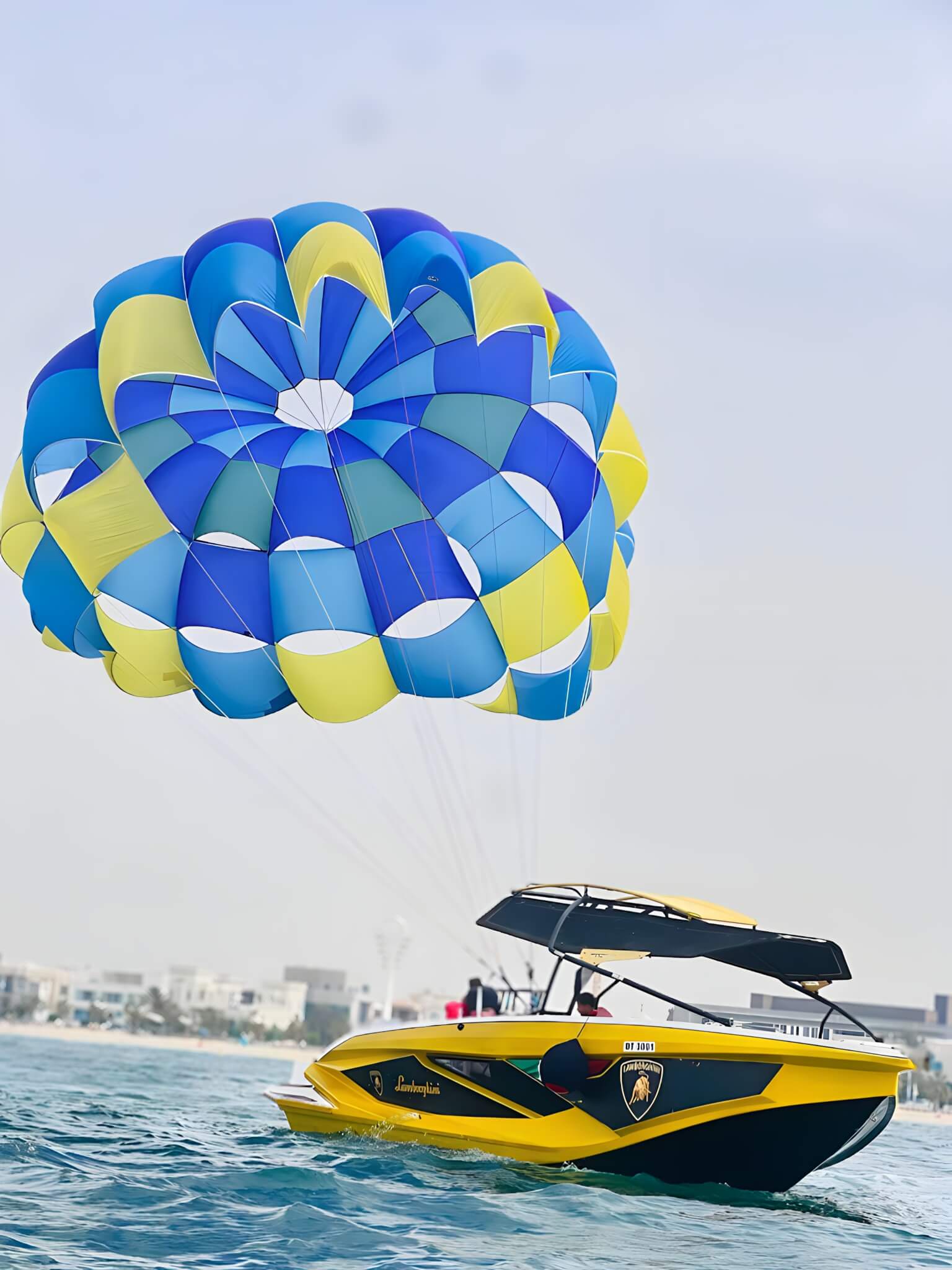 Parasailing high above the Arabian Gulf with the Dubai coastline below