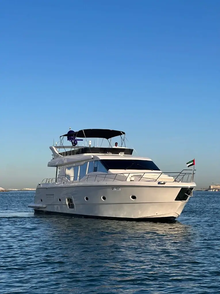 Yacht cruising past the Dubai coastline in the evening light